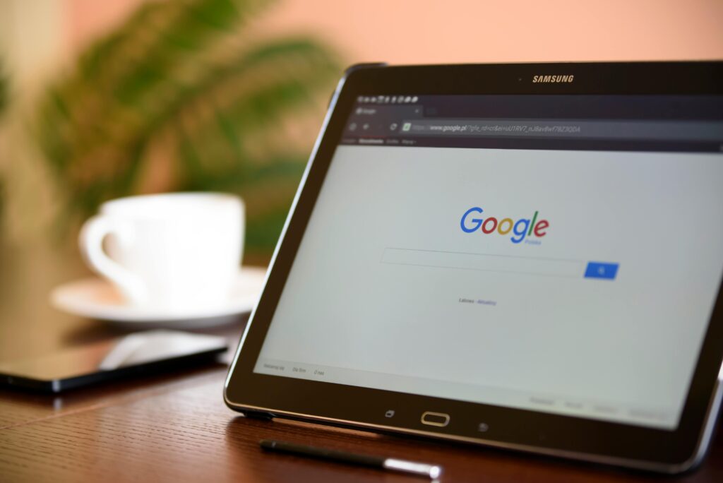 Samsung tablet on desk showing Google homepage, perfect for technology-related content.